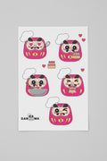 A sheet of five pink Daruma stickers .Our Pastry Chef Andy! The brand logo on the bottom-left corner with white background.